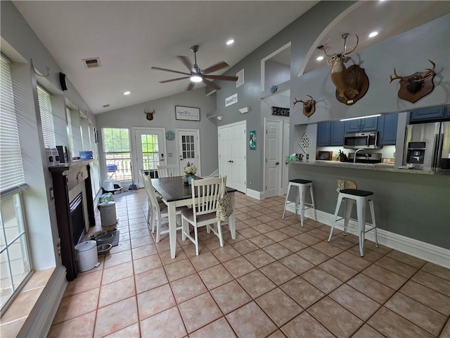 dining room featuring recessed lighting, light tile patterned floors, ceiling fan, a glass covered fireplace, and visible vents