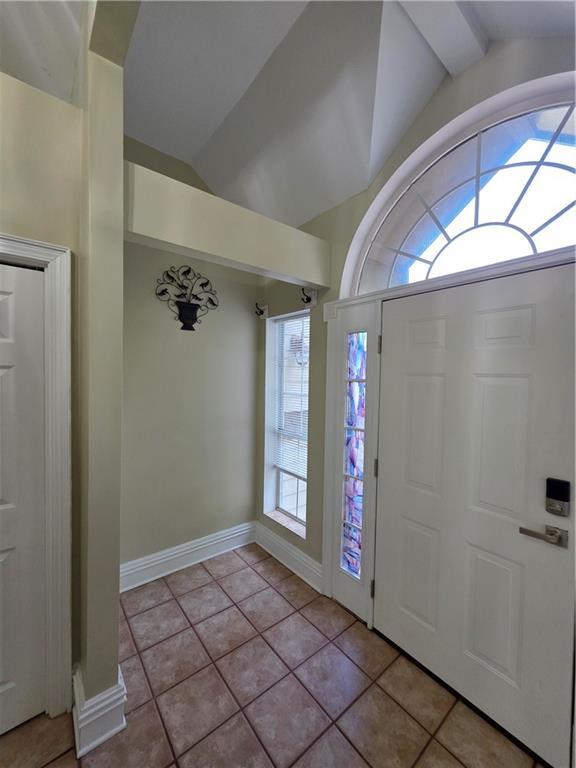 200 Valley Brook Dr, Newnan, GA 30265 - entryway featuring lofted ceiling, tile patterned floors, and baseboards