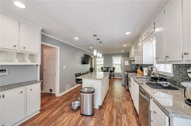2165 Shillings Chase Dr NW, Kennesaw, GA 30152 - kitchen featuring stainless steel appliances, dark wood finished floors, a kitchen island, a sink, and ornamental molding