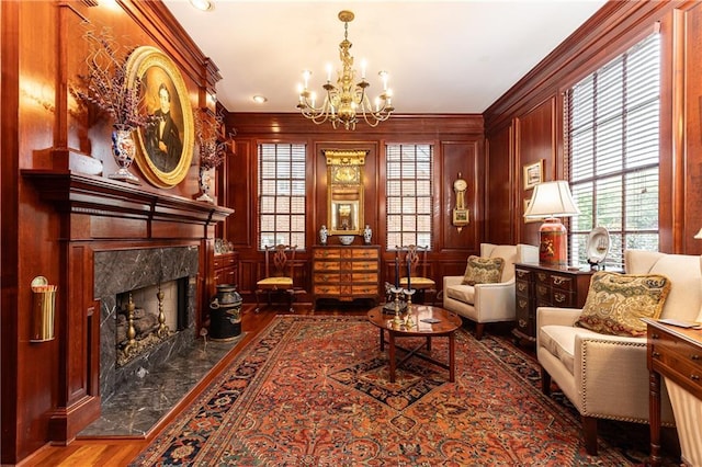 3022 Loridan Way SE, Atlanta, GA 30339 - sitting room with a chandelier, ornamental molding, a fireplace, wood finished floors, and a decorative wall