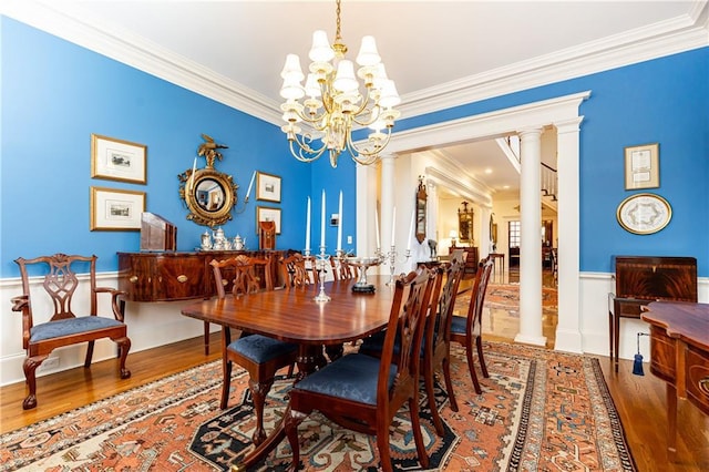 3022 Loridan Way SE, Atlanta, GA 30339 - dining room with wood finished floors, crown molding, wainscoting, a chandelier, and decorative columns