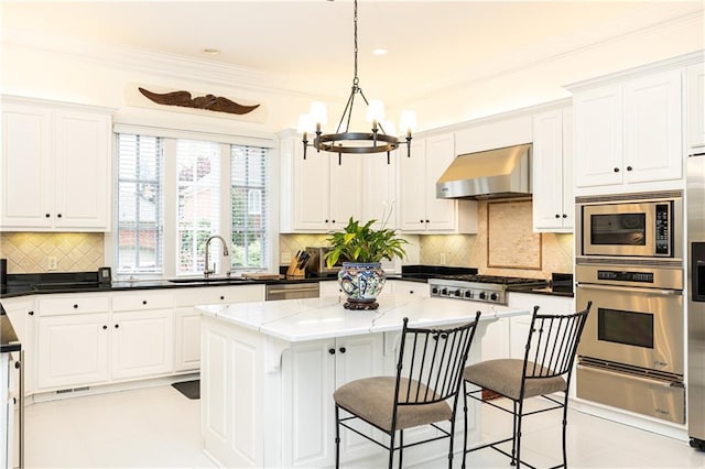 3022 Loridan Way SE, Atlanta, GA 30339 - kitchen with appliances with stainless steel finishes, a sink, a warming drawer, wall chimney exhaust hood, and a chandelier