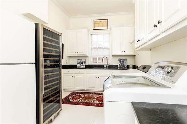 3022 Loridan Way SE, Atlanta, GA 30339 - laundry room featuring washing machine and clothes dryer, cabinet space, and crown molding