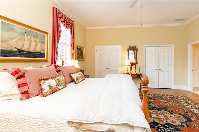 3022 Loridan Way SE, Atlanta, GA 30339 - bedroom featuring multiple closets, ornamental molding, wood finished floors, a ceiling fan, and baseboards