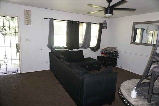 carpeted living room with ceiling fan