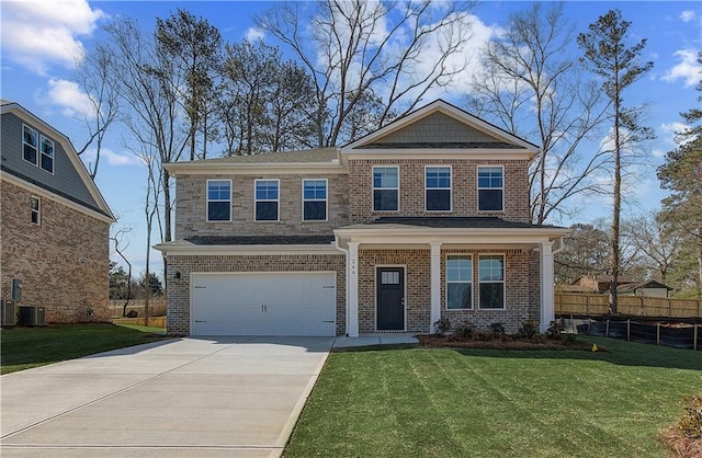 craftsman inspired home featuring a front yard, concrete driveway, fence, and brick siding