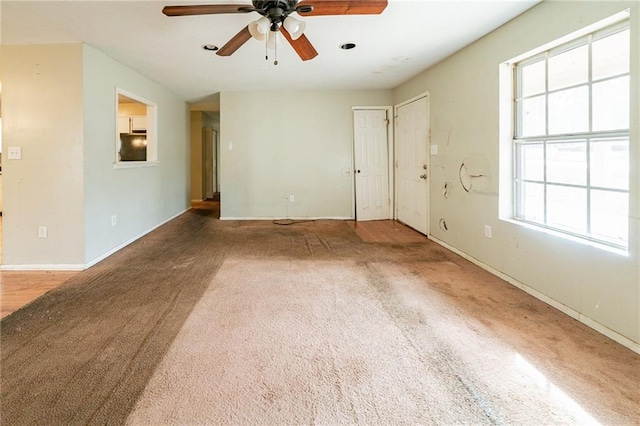 carpeted empty room with a textured ceiling and ceiling fan