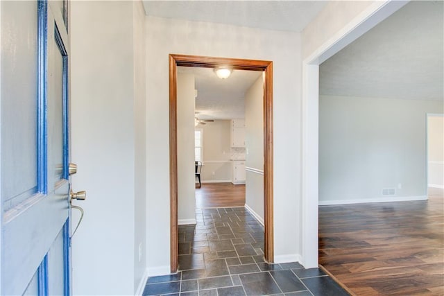 hallway with dark hardwood / wood-style flooring