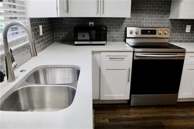 1191 Hampton Way NE, Atlanta, GA 30324 - kitchen featuring stainless steel range with electric stovetop, black microwave, white cabinetry, backsplash, and light countertops