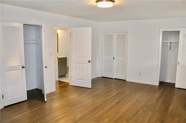 1191 Hampton Way NE, Atlanta, GA 30324 - unfurnished bedroom featuring two closets and wood finished floors