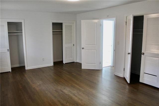 1191 Hampton Way NE, Atlanta, GA 30324 - unfurnished bedroom with multiple closets and dark wood-type flooring