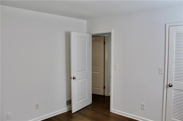 1191 Hampton Way NE, Atlanta, GA 30324 - unfurnished bedroom featuring dark wood finished floors and baseboards