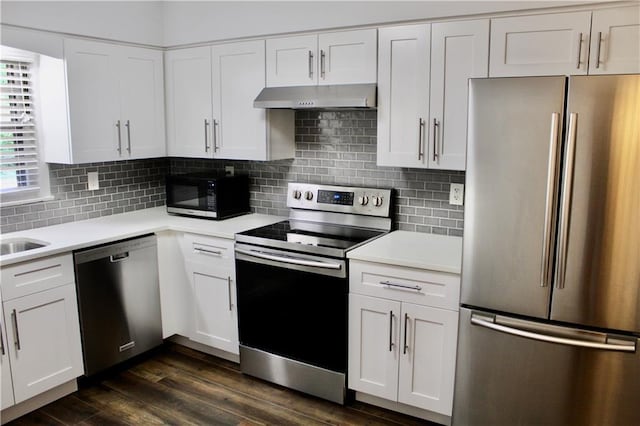 1191 Hampton Way NE, Atlanta, GA 30324 - kitchen with stainless steel appliances, under cabinet range hood, light countertops, white cabinetry, and tasteful backsplash