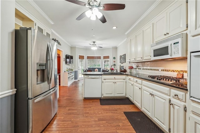 kitchen featuring sink, white cabinetry, appliances with stainless steel finishes, and kitchen peninsula