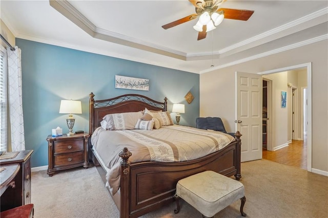 bedroom featuring crown molding, a tray ceiling, and ceiling fan