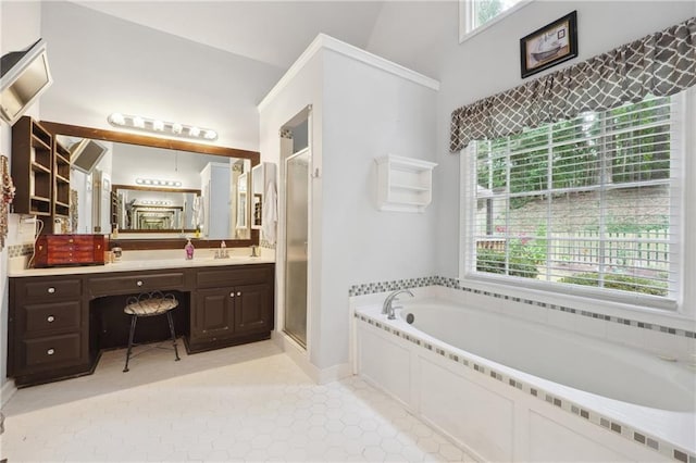 bathroom featuring plenty of natural light, vanity, and separate shower and tub