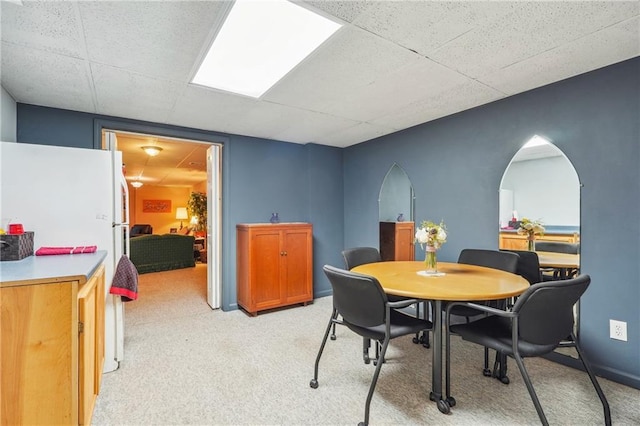 dining space featuring light colored carpet