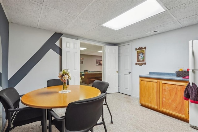 dining area with a drop ceiling