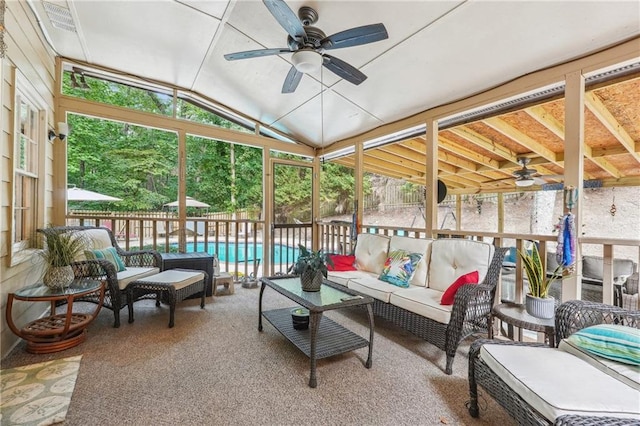 sunroom / solarium featuring ceiling fan and lofted ceiling