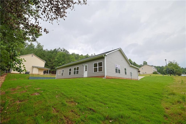 275 Green Commons Dr, Covington, GA 30016 - rear view of property with a yard