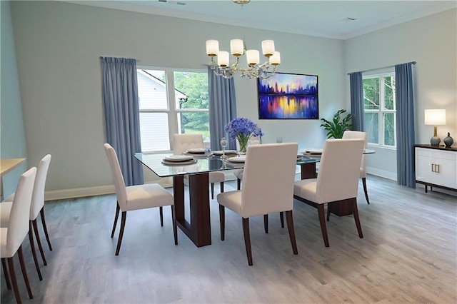 275 Green Commons Dr, Covington, GA 30016 - dining space with a chandelier, light wood-type flooring, ornamental molding, and baseboards