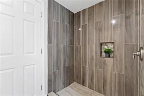 bathroom with a tile shower