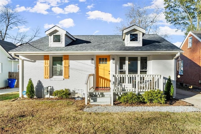 view of front of home featuring covered porch and a front yard