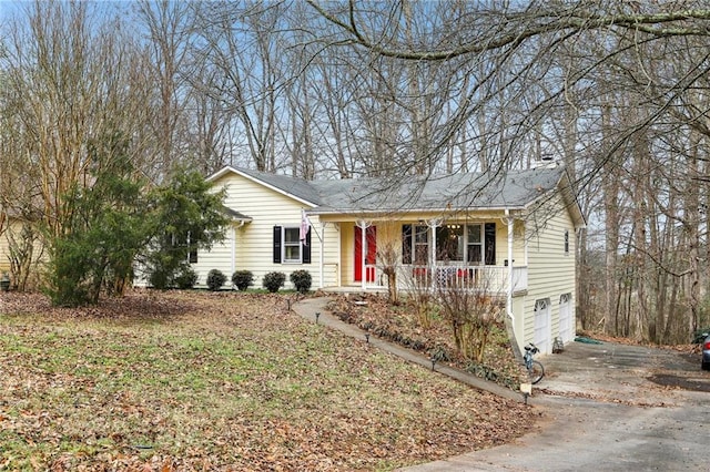 ranch-style house with a garage and covered porch