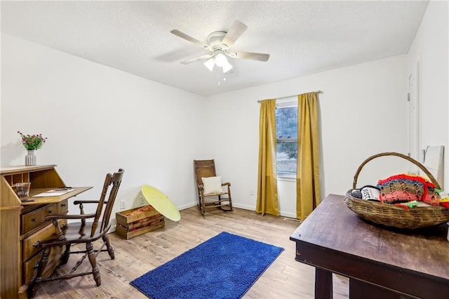 office area featuring a textured ceiling, light hardwood / wood-style floors, and ceiling fan