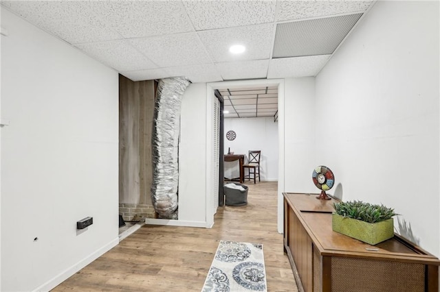 corridor featuring light hardwood / wood-style floors and a drop ceiling