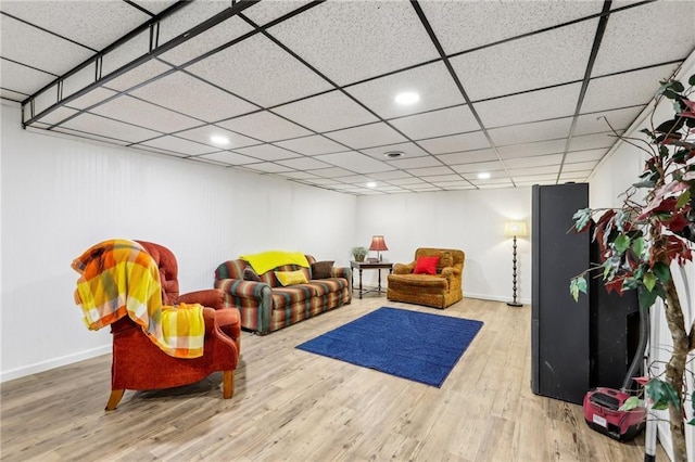 recreation room with a drop ceiling and hardwood / wood-style flooring