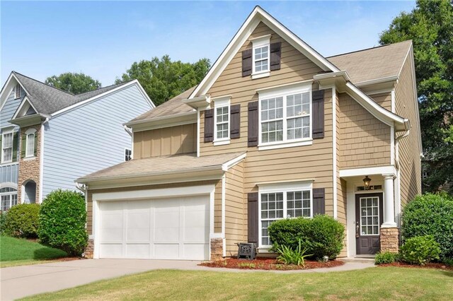 view of front facade featuring a front lawn and a garage