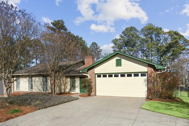 ranch-style home with a garage, driveway, brick siding, and a chimney