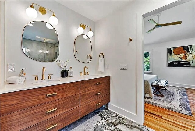 bathroom with ceiling fan, hardwood / wood-style floors, and vanity