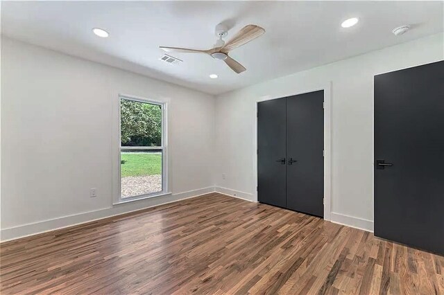 unfurnished bedroom with ceiling fan and hardwood / wood-style floors