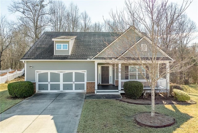 craftsman-style house with a garage, covered porch, and a front lawn