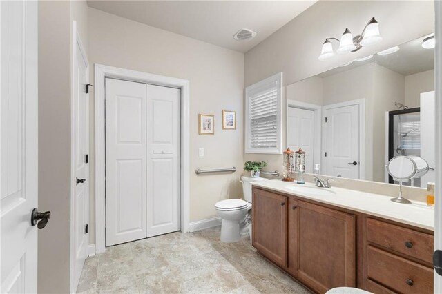 bathroom featuring vanity and toilet