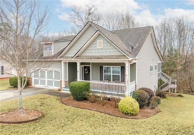 view of front of house with a garage, a porch, and a front lawn