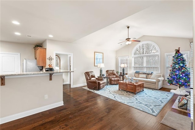 living room with ceiling fan, lofted ceiling, and dark hardwood / wood-style flooring