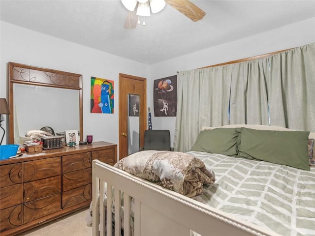 bedroom featuring light carpet and ceiling fan