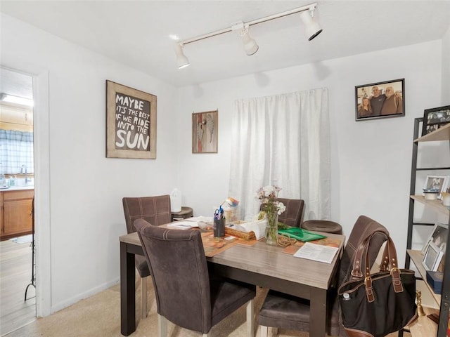 carpeted dining area with sink