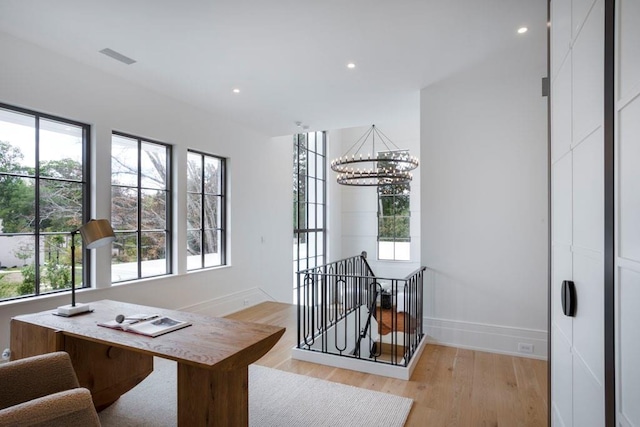 office area featuring a chandelier and light hardwood / wood-style flooring