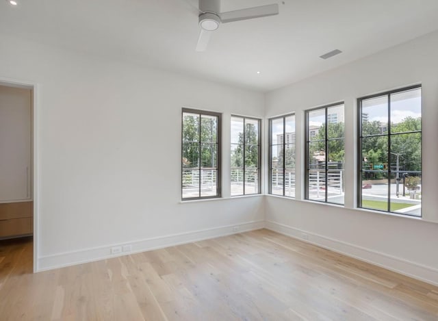 unfurnished room featuring ceiling fan and light wood-type flooring