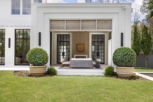 doorway to property with a yard and outdoor lounge area