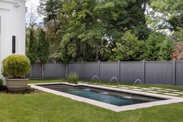 view of pool with a lawn and pool water feature