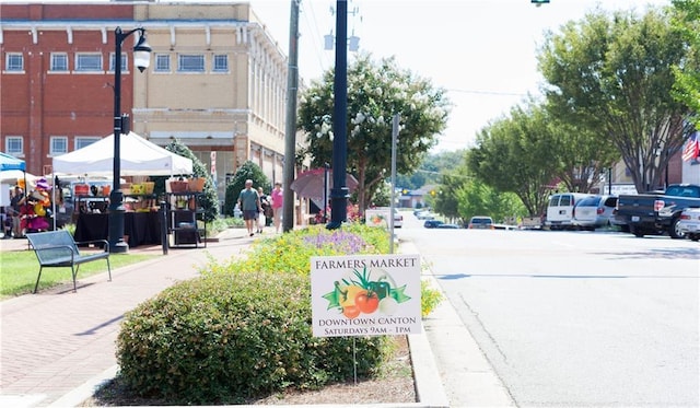 view of street with sidewalks, street lighting, and curbs