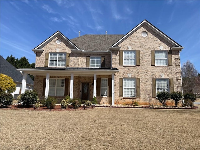 view of front of property with brick siding and a porch