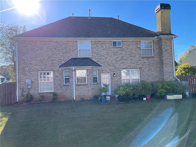 rear view of property with a lawn