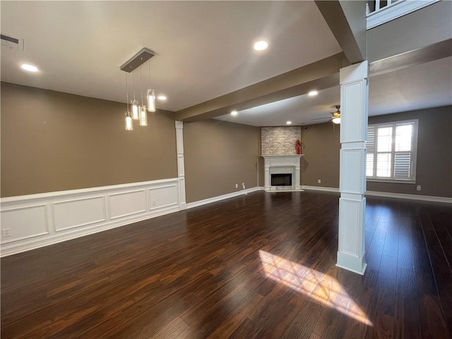 basement featuring ceiling fan, recessed lighting, a large fireplace, visible vents, and dark wood-style floors