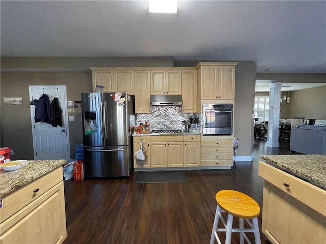 kitchen featuring dark hardwood / wood-style floors, decorative backsplash, light stone countertops, and appliances with stainless steel finishes